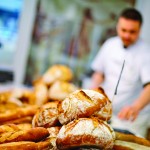 Traditional bread close up with baker at the backgorund