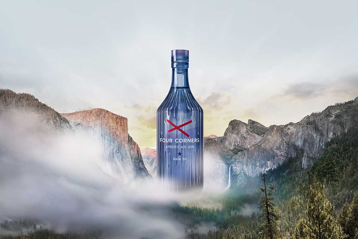 Bottle of Four Corners Gin against a background of mountains.