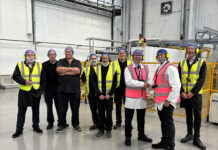 Andrew Cooper MP (third from right) and Sujoy Bose, Coveris Winsford Managing Director (second from right) alongside Coveris Winsford employees for the conversion hall opening.