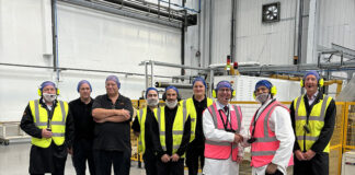 Andrew Cooper MP (third from right) and Sujoy Bose, Coveris Winsford Managing Director (second from right) alongside Coveris Winsford employees for the conversion hall opening.